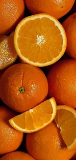 Fresh juicy oranges with sliced segments, vibrant citrus wallpaper.