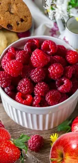 Fresh raspberries in a bowl with cookies and apples, vibrant phone wallpaper.