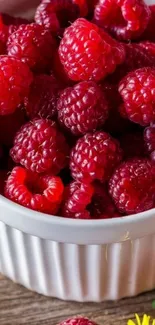 Fresh raspberries overflowing in a white ceramic bowl.