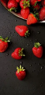 Fresh strawberries scattered on dark background.