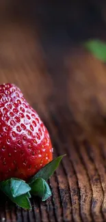 Fresh strawberries on dark wooden table in vibrant mobile wallpaper.