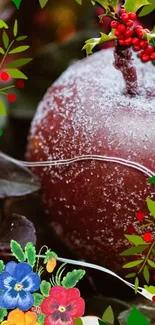 Frosted red apple with green leaves and colorful flowers.