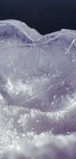 Frozen heart in snow with sparkling light effect.