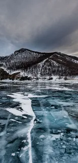 Majestic frozen mountain lake with icy surface and snow-covered peaks.