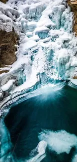 Frozen waterfall with turquoise pool in rocky landscape.