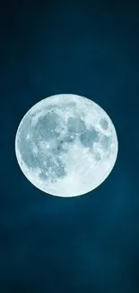 Full moon shining in a dark blue night sky.