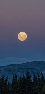 Full moon rising over a scenic mountain landscape during twilight.