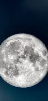 Full moon against a dark blue night sky, capturing cosmic beauty.