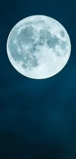 A full moon shining brightly against a dark blue night sky.