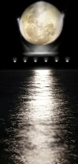 Full moon glowing over the ocean's reflective surface at night.