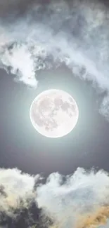 Full moon surrounded by clouds in the night sky, creating a serene visual.