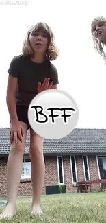 Two friends having fun outdoors with a BFF sign.