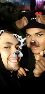 Two friends with dog face filters smiling for a selfie at night.