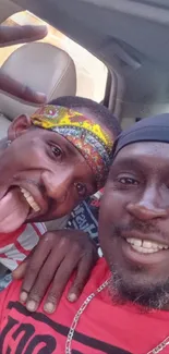 Two friends enjoying a car selfie with vibrant colors and smiles.