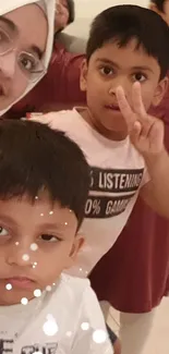 Lively group selfie with smiling children in playful poses.