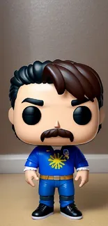 Funko Pop figure with blue outfit and brown hair, on beige background.