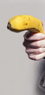 Hand holding a banana in a quirky wallpaper design.