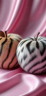 Fur-textured apples on pink silk