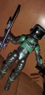 Futuristic action figure with weapon set against wooden backdrop.