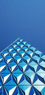 Futuristic geometric design against a blue sky background.