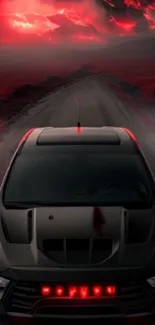 Futuristic car driving under red, dramatic skies on a deserted road.