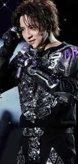 Futuristic performer in metallic armor on cosmic stage backdrop.