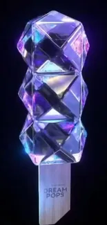 A glowing geometric crystal art against a dark background.