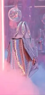 Holographic bag amidst pink glow and disco balls wallpaper.