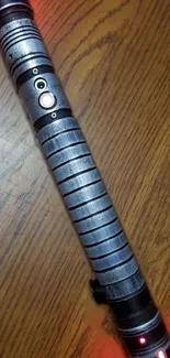 Futuristic metal handle with lighting effects on wooden surface.