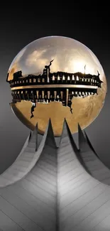 Futuristic sculpture with a golden sphere and silver base against a dark backdrop.