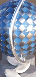Silver and blue globe with a futuristic design on a pedestal.