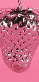 Metallic silver strawberry on pink background.