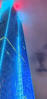 Futuristic skyscraper with vibrant neon lights at night.