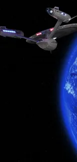 Futuristic spacecraft orbiting Earth in deep space.