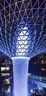 Futuristic geometric dome with illuminated waterfall.