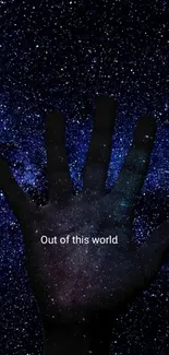 Silhouette hand against starry galaxy wallpaper.