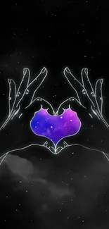 Galaxy heart framed by hands on black starry background.