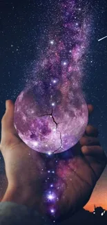 Surreal hand holding a galaxy art wallpaper with cosmic elements.