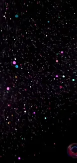 Colorful galaxy sprinkle wallpaper with vibrant dots on a black background.