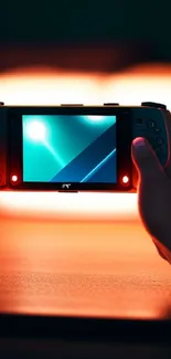 Hands holding a gaming console with a neon screen glow.