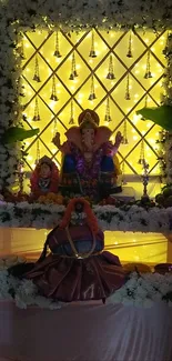 Ganesh festival decoration with yellow lighting and floral garlands.