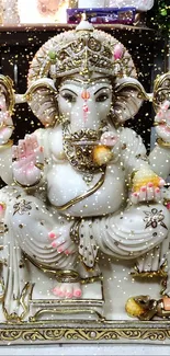 Intricate Ganesha statue on decorative mobile wallpaper.