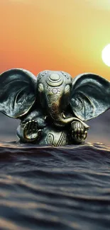 Ganesha statue in sunset with ocean waves.