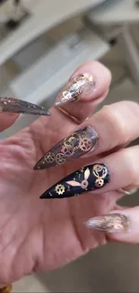 Close-up of steampunk gear nail art with metallic accents.