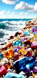 Colorful gemstones on a sunny beach with ocean waves and clouds.