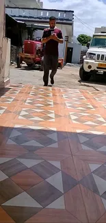 Geometric pattern on a driveway with intricate brown tiles.