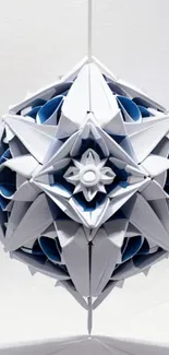 Intricate geometric origami ball hanging against a white background.