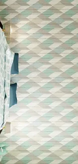 Pastel geometric wallpaper in a modern bedroom with teal and beige tones.