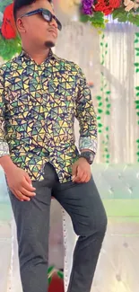 Stylish man in geometric pattern shirt posing confidently.