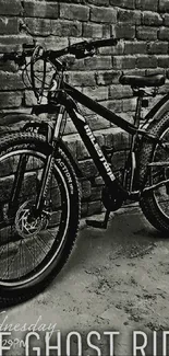 Monochrome bicycle beside a brick wall.